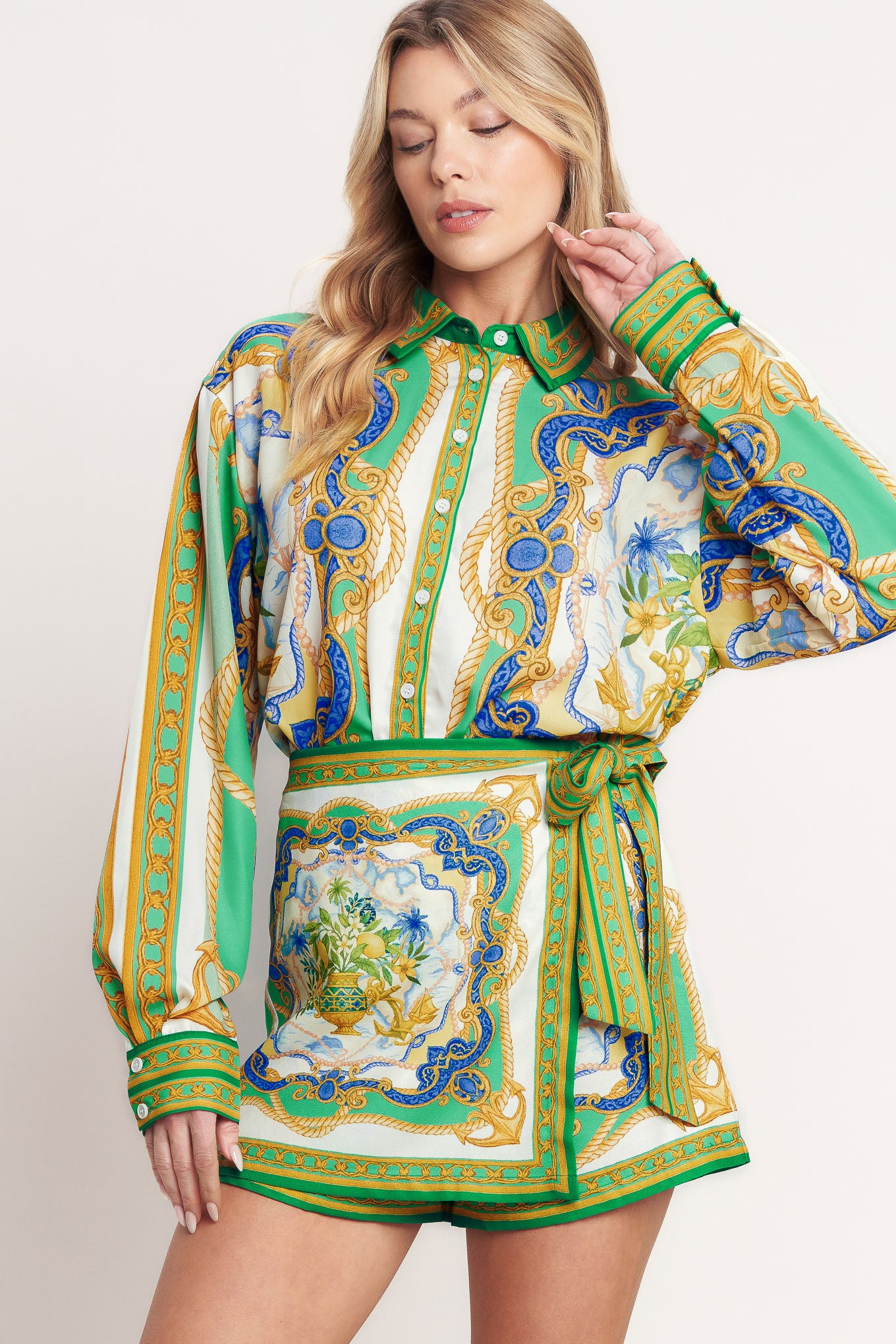 
A printed woven button down top with long sleeve. Matching skort IP9107T

Details:

Self : 100% Polyester

Size &amp; Fit

- Model is 5`8" And Wearing Size Small
- Measurements Taken From Size Small
- Approx. Length: 26"