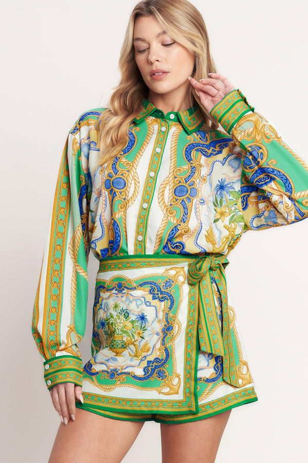 
A printed woven button down top with long sleeve. Matching skort IP9107T

Details:

Self : 100% Polyester

Size &amp; Fit

- Model is 5`8" And Wearing Size Small
- Measurements Taken From Size Small
- Approx. Length: 26"