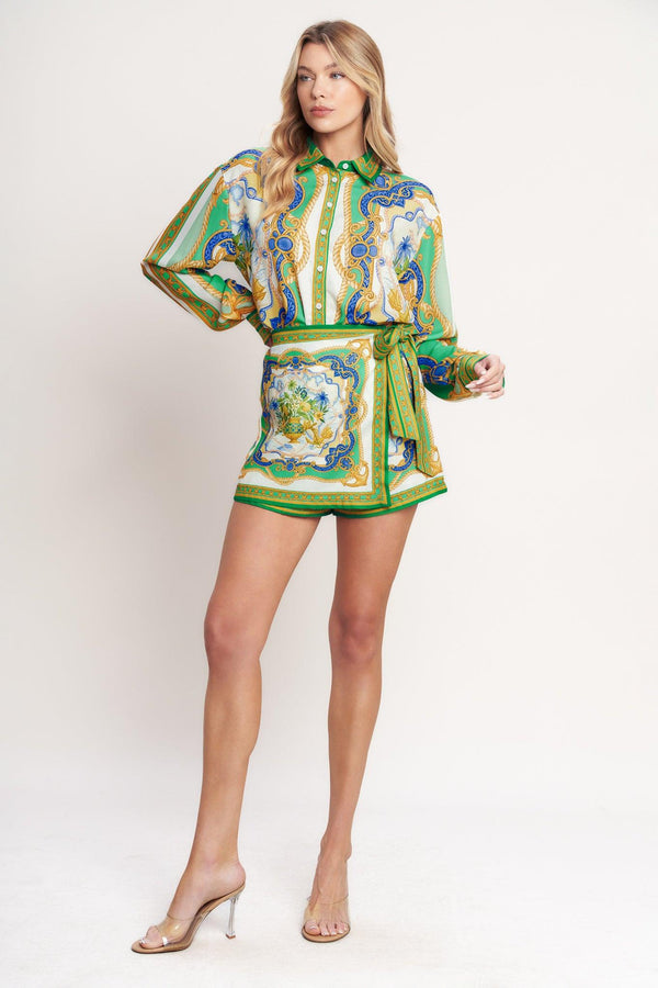 
A printed woven button down top with long sleeve. Matching skort IP9107T

Details:

Self : 100% Polyester

Size &amp; Fit

- Model is 5`8" And Wearing Size Small
- Measurements Taken From Size Small
- Approx. Length: 26"