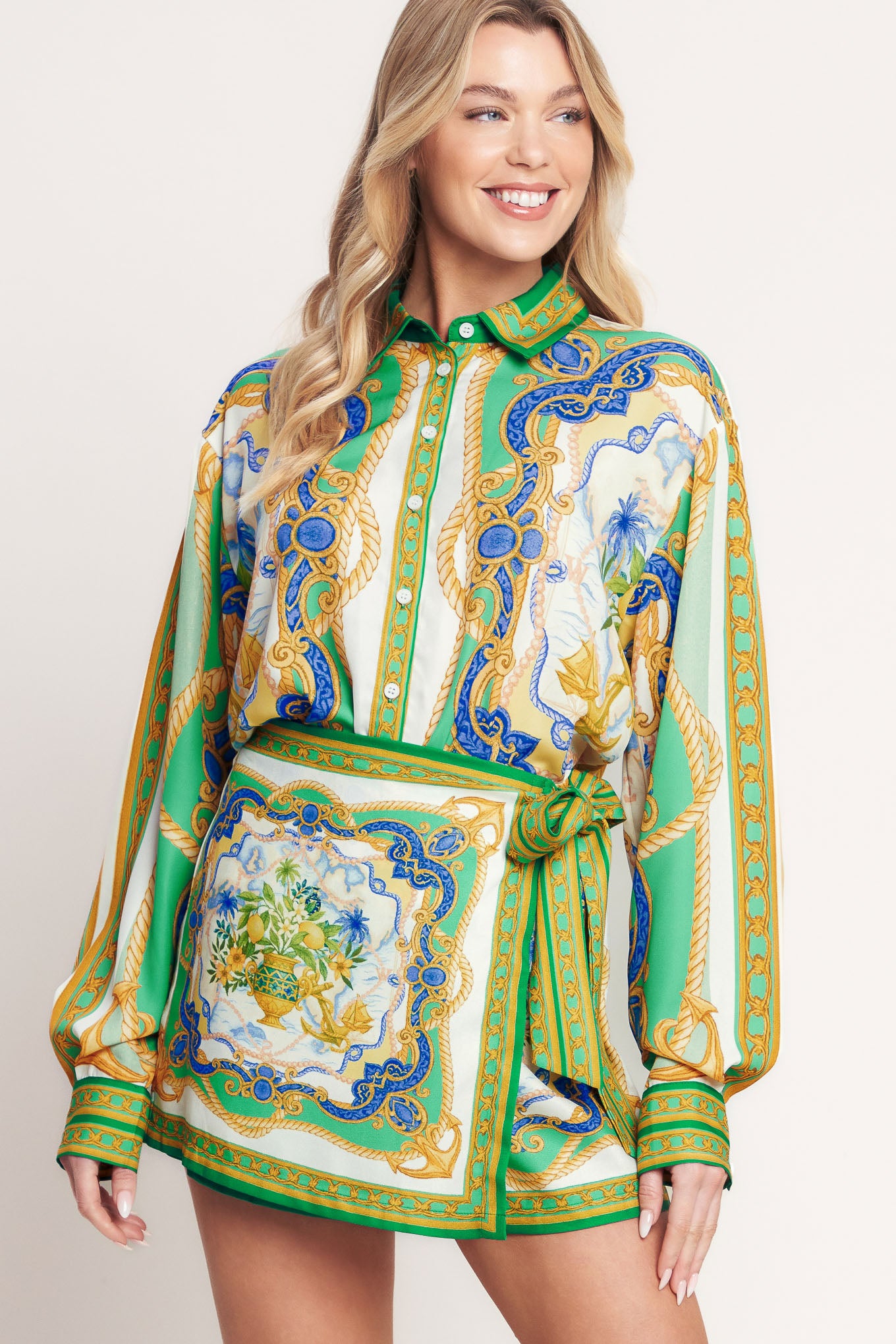 
A printed woven button down top with long sleeve. Matching skort IP9107T

Details:

Self : 100% Polyester

Size &amp; Fit

- Model is 5`8" And Wearing Size Small
- Measurements Taken From Size Small
- Approx. Length: 26"