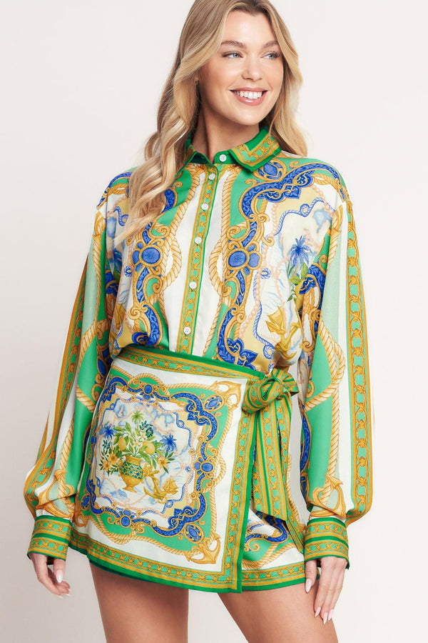 
A printed woven button down top with long sleeve. Matching skort IP9107T

Details:

Self : 100% Polyester

Size &amp; Fit

- Model is 5`8" And Wearing Size Small
- Measurements Taken From Size Small
- Approx. Length: 26"