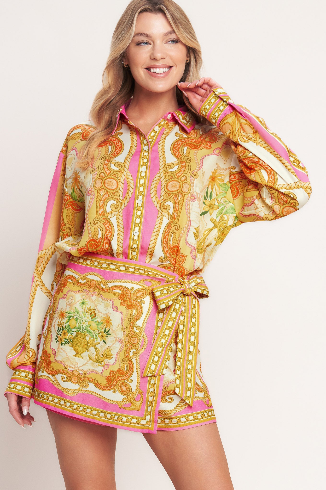 
A printed woven button down top with long sleeve. Matching skort IP9107T

Details:

Self : 100% Polyester

Size &amp; Fit

- Model is 5`8" And Wearing Size Small
- Measurements Taken From Size Small
- Approx. Length: 26"