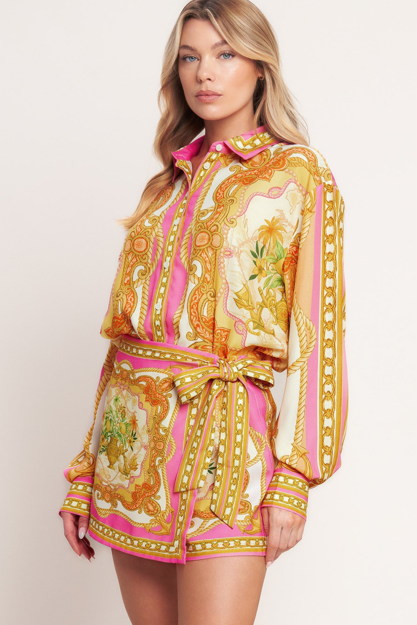 
A printed woven button down top with long sleeve. Matching skort IP9107T

Details:

Self : 100% Polyester

Size &amp; Fit

- Model is 5`8" And Wearing Size Small
- Measurements Taken From Size Small
- Approx. Length: 26"