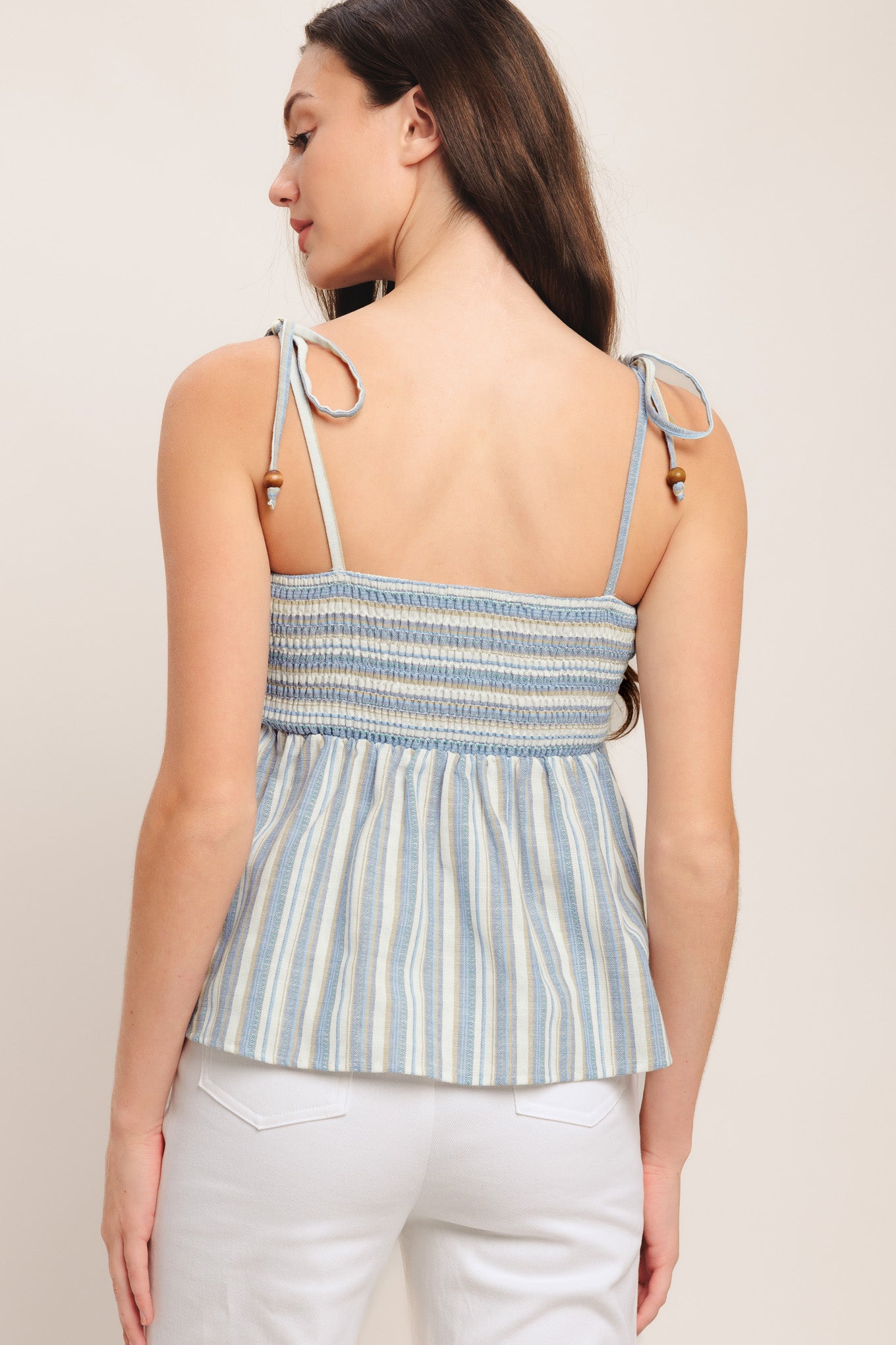A striped woven top featuring straight neckline, shoulder tie and smocked bodice. Matching pant IP9116T

Details:

Self: 60% Polyester 20% Cotton 20% Linen

Size & Fit

-Model is 5`8" And Wearing Size Small
-Measurements Taken From Size Small
-Approx. Length: 21"
