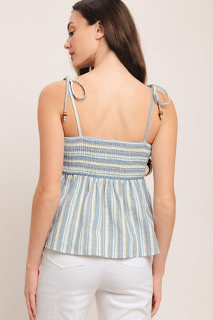 A striped woven top featuring straight neckline, shoulder tie and smocked bodice. Matching pant IP9116T

Details:

Self: 60% Polyester 20% Cotton 20% Linen

Size & Fit

-Model is 5`8" And Wearing Size Small
-Measurements Taken From Size Small
-Approx. Length: 21"