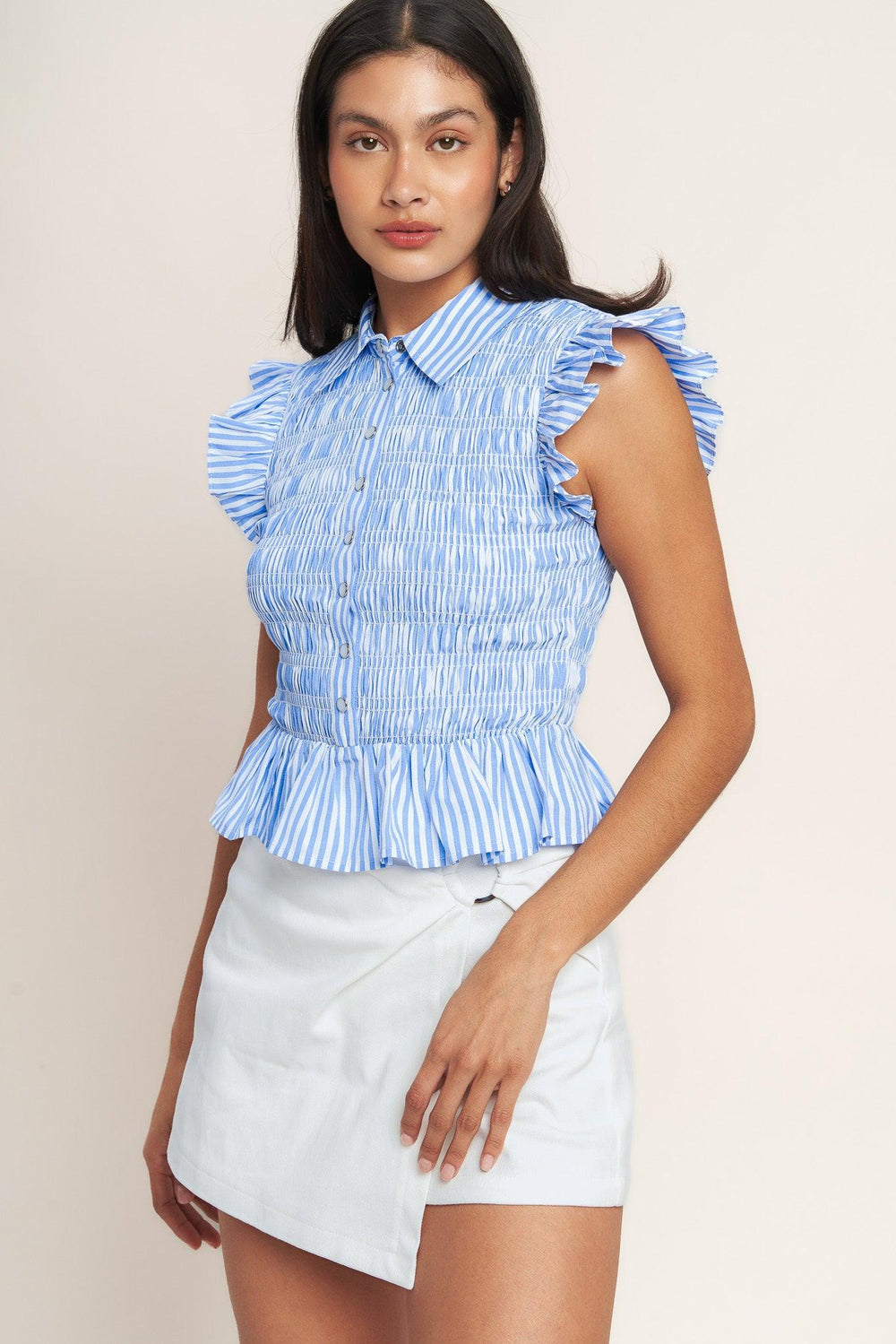 
A striped woven top featuring collar, ruffle sleeve, button down, smocked bodice and peplum

Details:

Self : 60% Cotton 40% Polyester

Size &amp; Fit

- Model is 5`8" And Wearing Size Small
- Measurements Taken From Size Small
- Approx. Length: 20" Flying Tomato