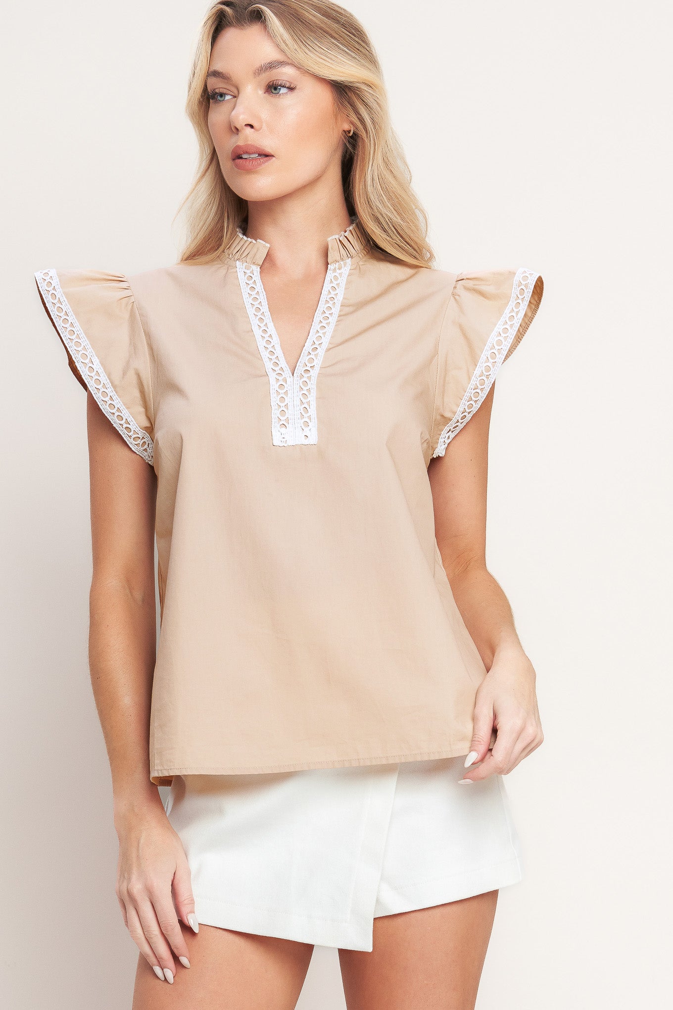A solid woven top featuring ruffled high neck with V front, ruffle sleeve and lace edge detail

Details:

Self: 100% Cotton Exclusive of Decoration

Size & Fit

-Model is 5`8" And Wearing Size Small
-Measurements Taken From Size Small
-Approx. Length: 24"