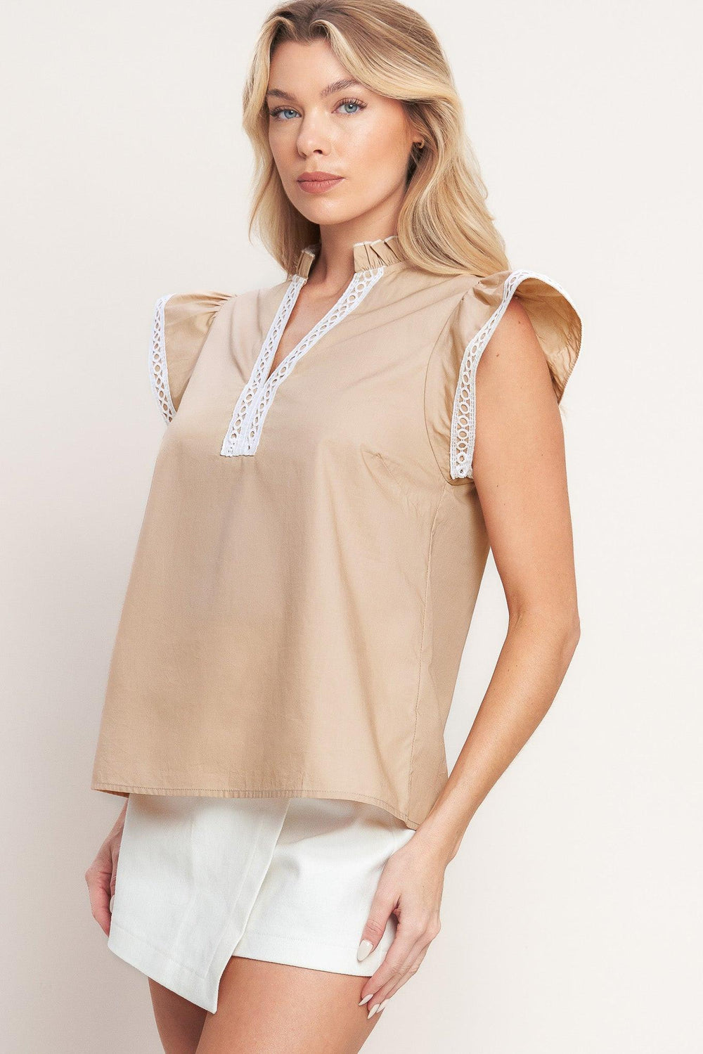 A solid woven top featuring ruffled high neck with V front, ruffle sleeve and lace edge detail

Details:

Self: 100% Cotton Exclusive of Decoration

Size & Fit

-Model is 5`8" And Wearing Size Small
-Measurements Taken From Size Small
-Approx. Length: 24"