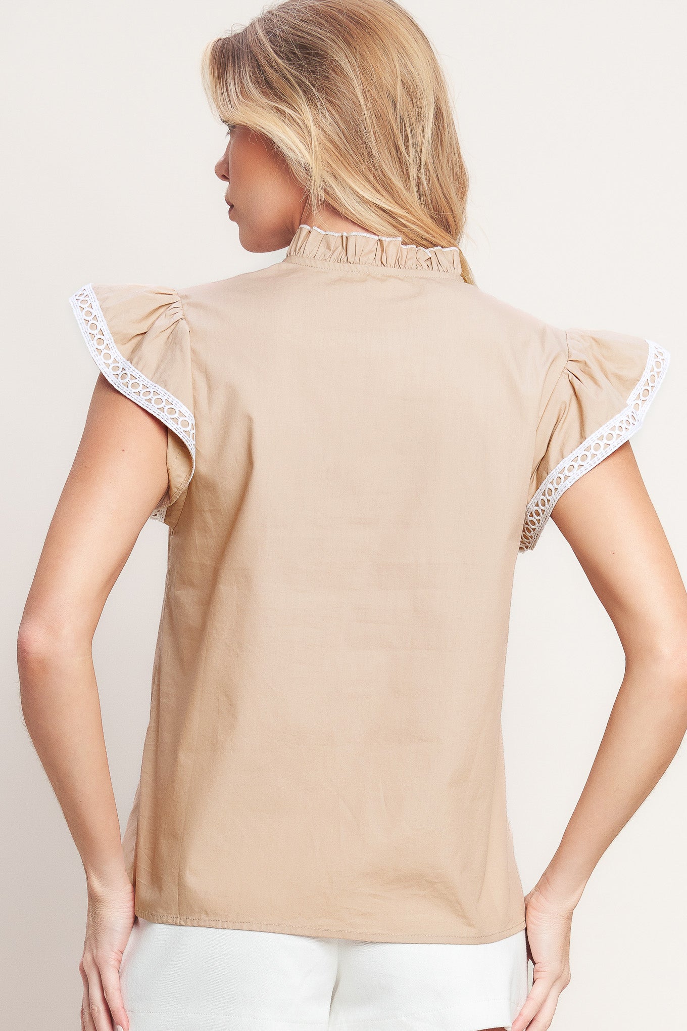 A solid woven top featuring ruffled high neck with V front, ruffle sleeve and lace edge detail

Details:

Self: 100% Cotton Exclusive of Decoration

Size & Fit

-Model is 5`8" And Wearing Size Small
-Measurements Taken From Size Small
-Approx. Length: 24"