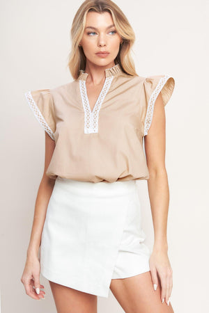 A solid woven top featuring ruffled high neck with V front, ruffle sleeve and lace edge detail

Details:

Self: 100% Cotton Exclusive of Decoration

Size & Fit

-Model is 5`8" And Wearing Size Small
-Measurements Taken From Size Small
-Approx. Length: 24"