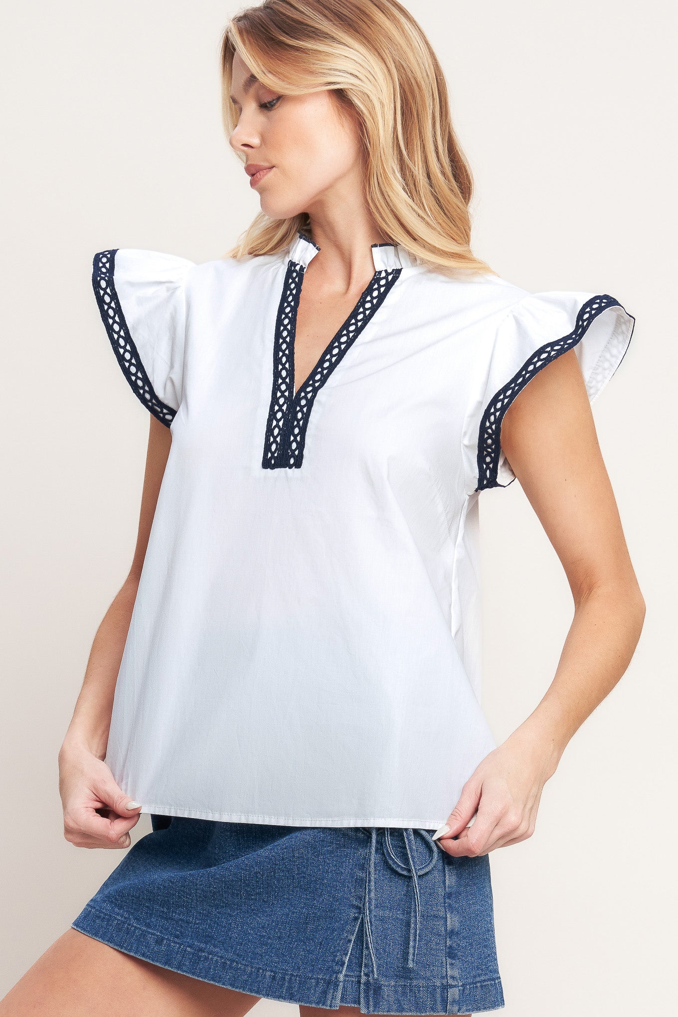 A solid woven top featuring ruffled high neck with V front, ruffle sleeve and lace edge detail

Details:

Self: 100% Cotton Exclusive of Decoration

Size & Fit

-Model is 5`8" And Wearing Size Small
-Measurements Taken From Size Small
-Approx. Length: 24"