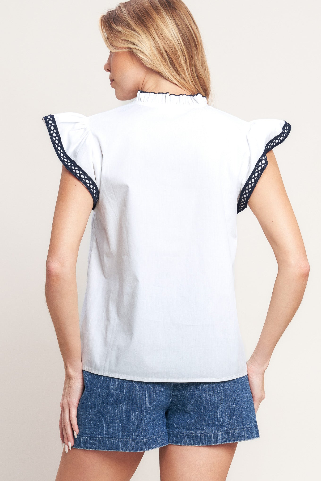 A solid woven top featuring ruffled high neck with V front, ruffle sleeve and lace edge detail

Details:

Self: 100% Cotton Exclusive of Decoration

Size & Fit

-Model is 5`8" And Wearing Size Small
-Measurements Taken From Size Small
-Approx. Length: 24"