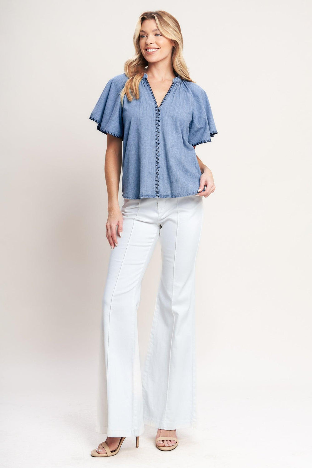 A solid woven top featuring V neckline, short flutter sleeve, button down and stitched edge

Details:

Self: 90% Cotton 10% Polyester

Size & Fit

-Model is 5`8" And Wearing Size Small
-Measurements Taken From Size Small
-Approx. Length: 25"