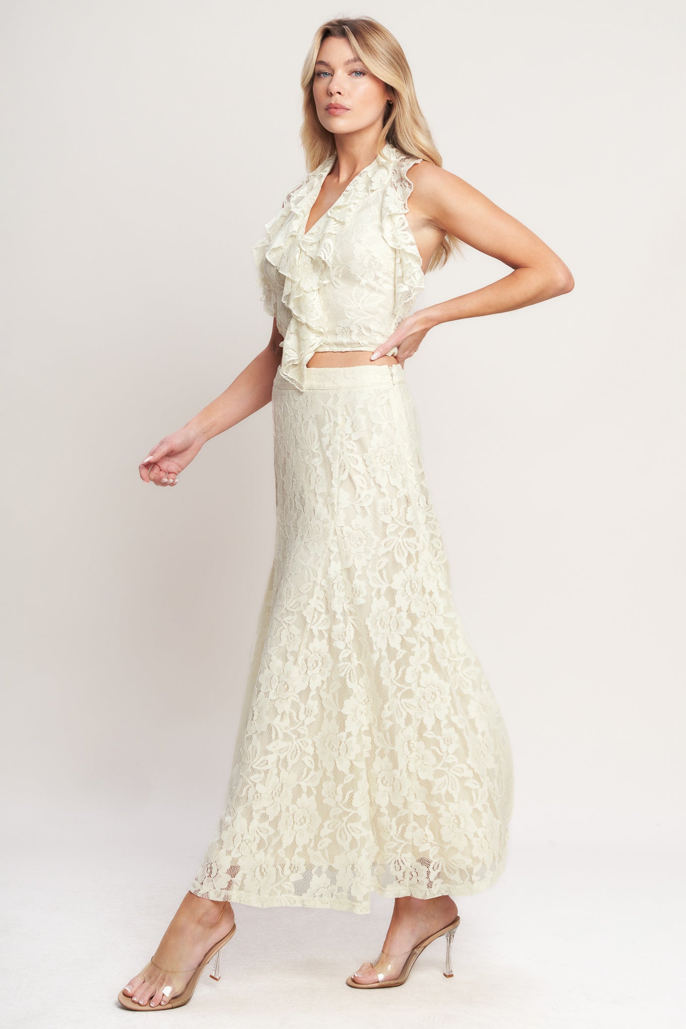 
A woven lace top featuring halter neckline, ruffles, tie back and smocked back bodice. Matching skirt IK7780T

Details:

Self : 90% Nylon 10% Spandex
Lining : 100% Polyester

Size &amp; Fit

- Model is 5`8" And Wearing Size Small
- Measurements Taken From Size Small
- Approx. Length: 18"