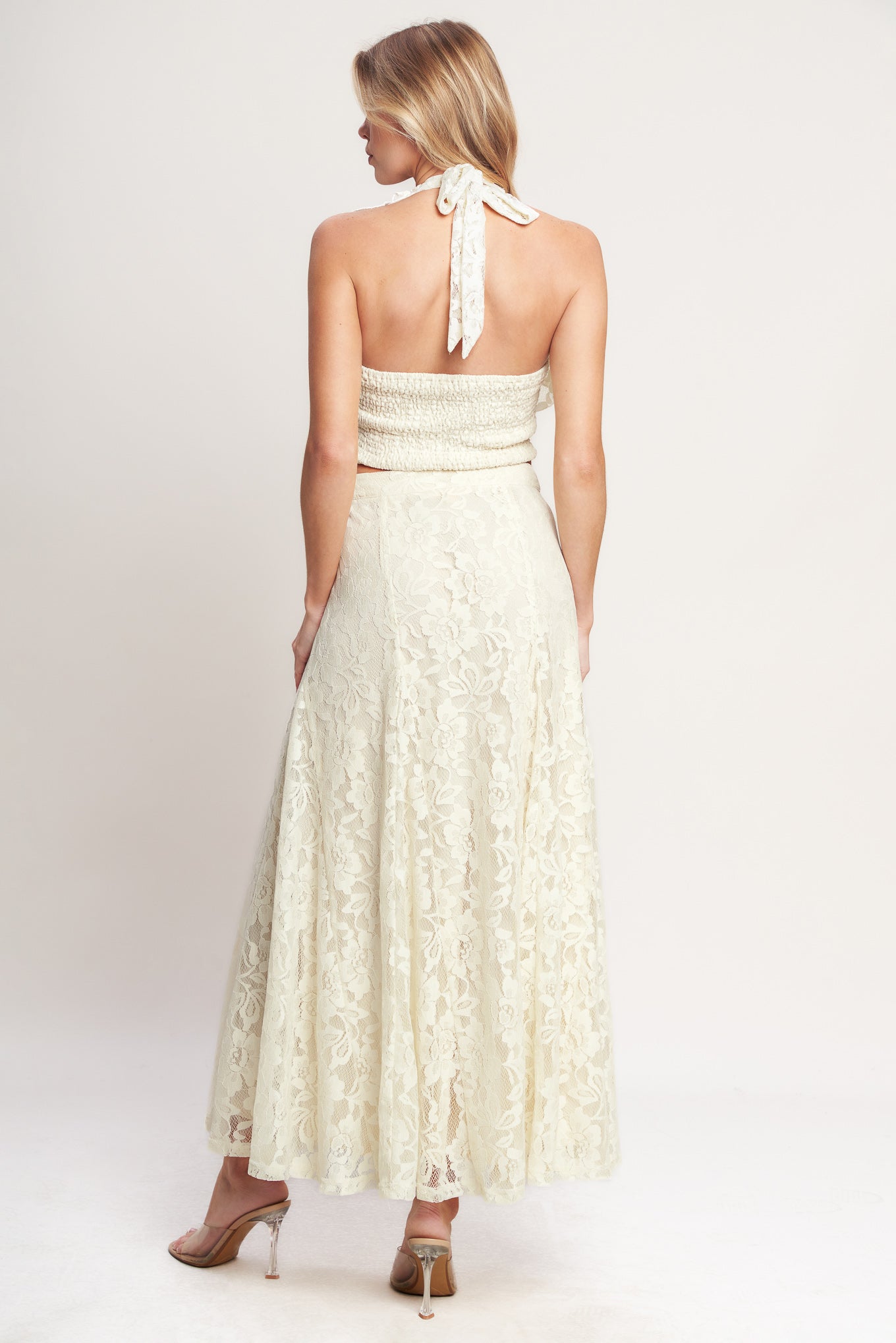 
A woven lace top featuring halter neckline, ruffles, tie back and smocked back bodice. Matching skirt IK7780T

Details:

Self : 90% Nylon 10% Spandex
Lining : 100% Polyester

Size &amp; Fit

- Model is 5`8" And Wearing Size Small
- Measurements Taken From Size Small
- Approx. Length: 18"