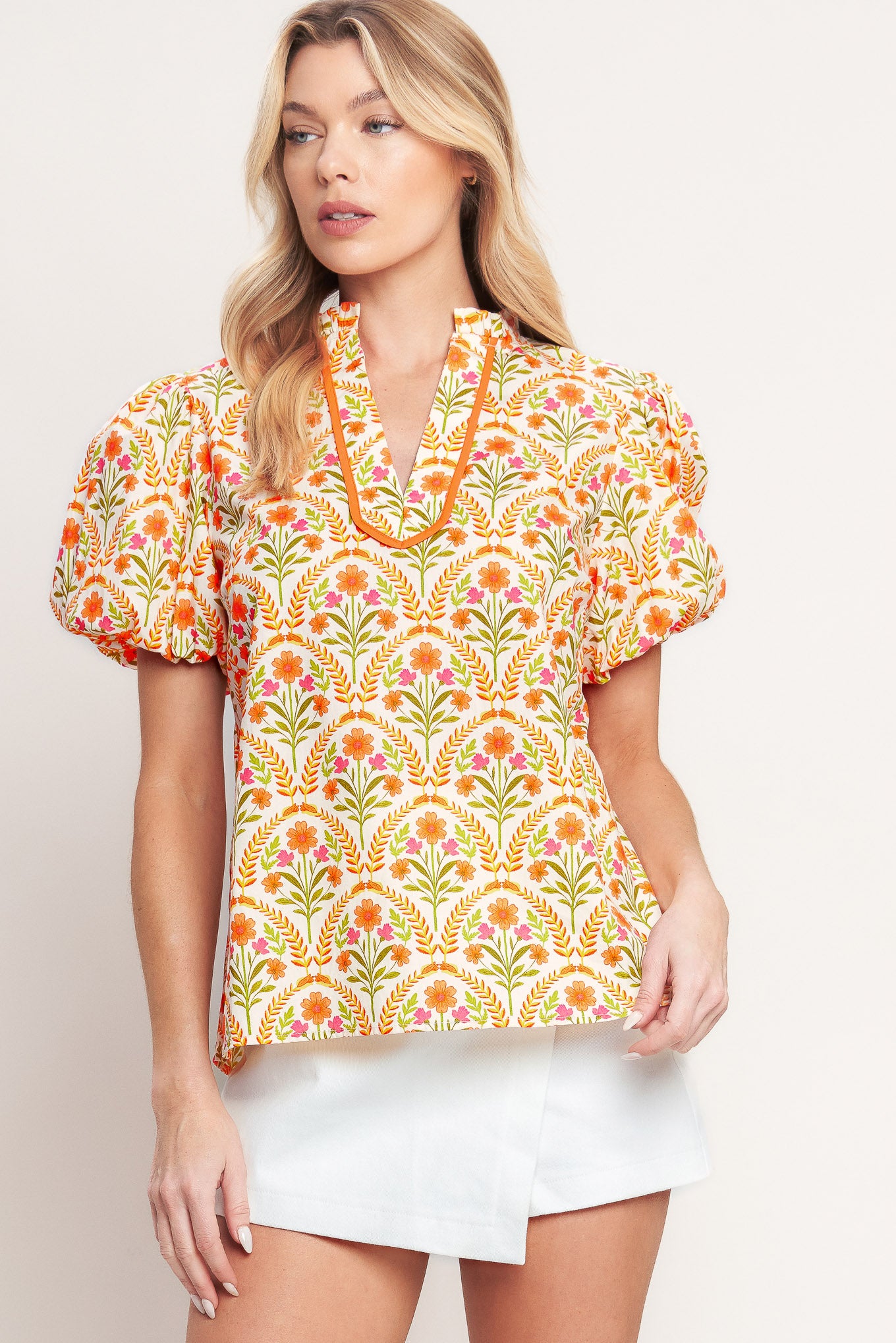 A printed woven top with ruffle neck with V front and short puff sleeve

Details:

Self: 100% Cotton

Size & Fit

-Model is 5`8" And Wearing Size Small
-Measurements Taken From Size Small
-Approx. Length: 25"