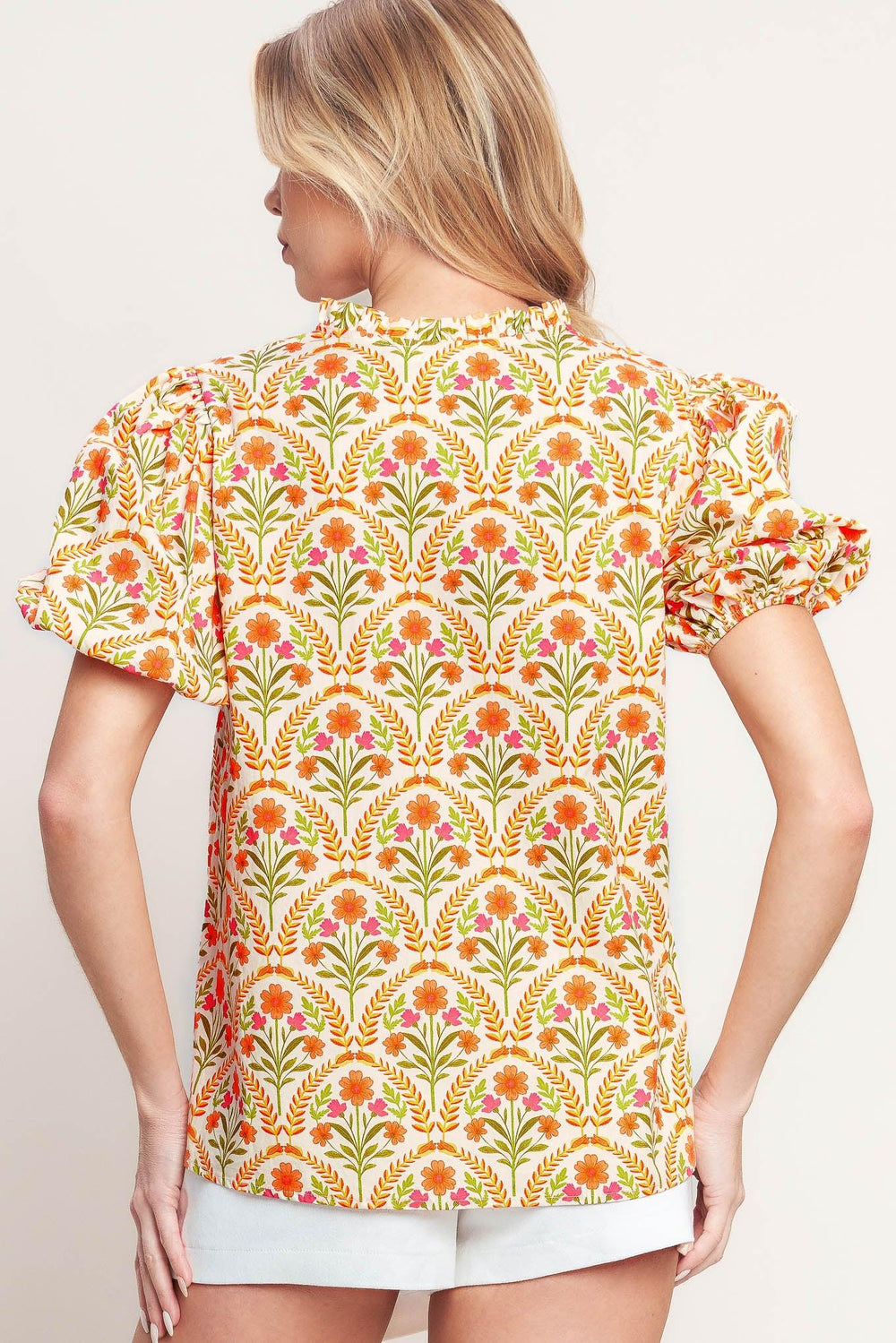 A printed woven top with ruffle neck with V front and short puff sleeve

Details:

Self: 100% Cotton

Size & Fit

-Model is 5`8" And Wearing Size Small
-Measurements Taken From Size Small
-Approx. Length: 25"