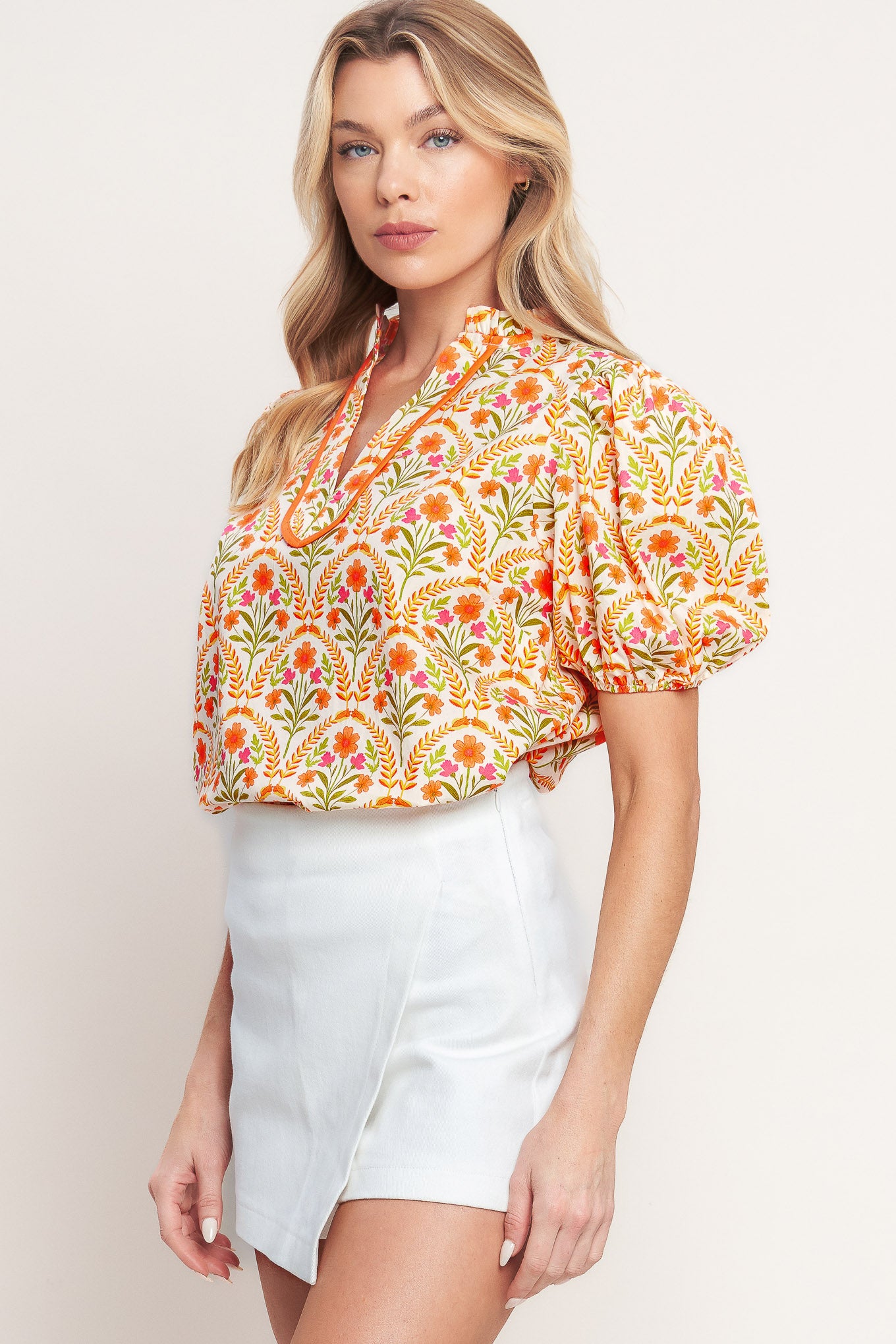 A printed woven top with ruffle neck with V front and short puff sleeve

Details:

Self: 100% Cotton

Size & Fit

-Model is 5`8" And Wearing Size Small
-Measurements Taken From Size Small
-Approx. Length: 25"