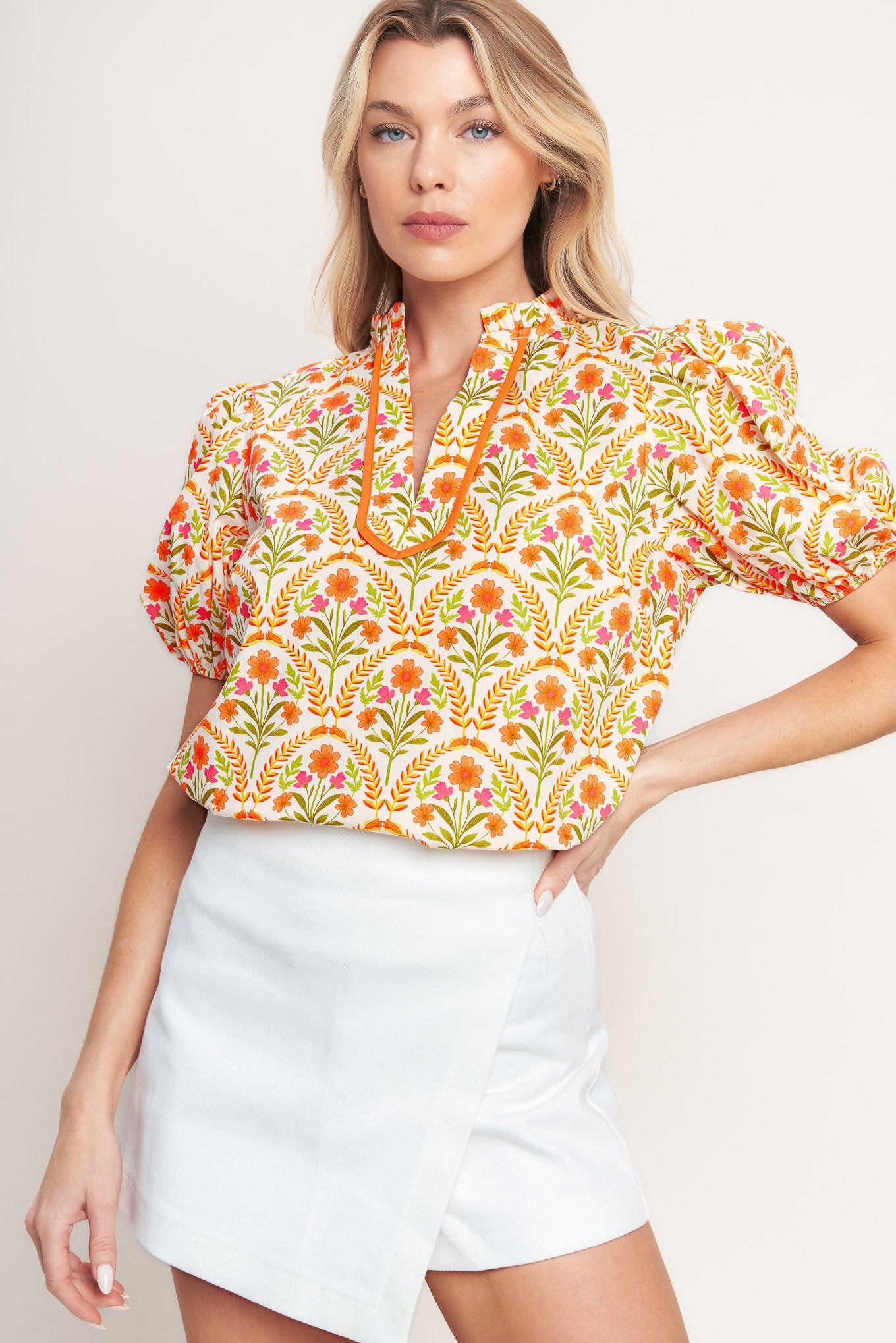 A printed woven top with ruffle neck with V front and short puff sleeve

Details:

Self: 100% Cotton

Size & Fit

-Model is 5`8" And Wearing Size Small
-Measurements Taken From Size Small
-Approx. Length: 25"