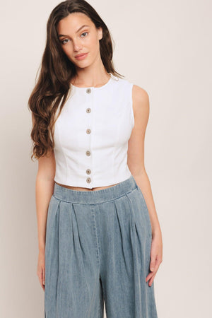 A solid woven crop top featuring round neckline, sleeveless and front button down closure. Matching skirt IK7784T

Details:

Self: 97% Cotton 3% Spandex

Size & Fit

-Model is 58 And Wearing Size Small
-Measurements Taken From Size Small
-Approx. Length: 20"