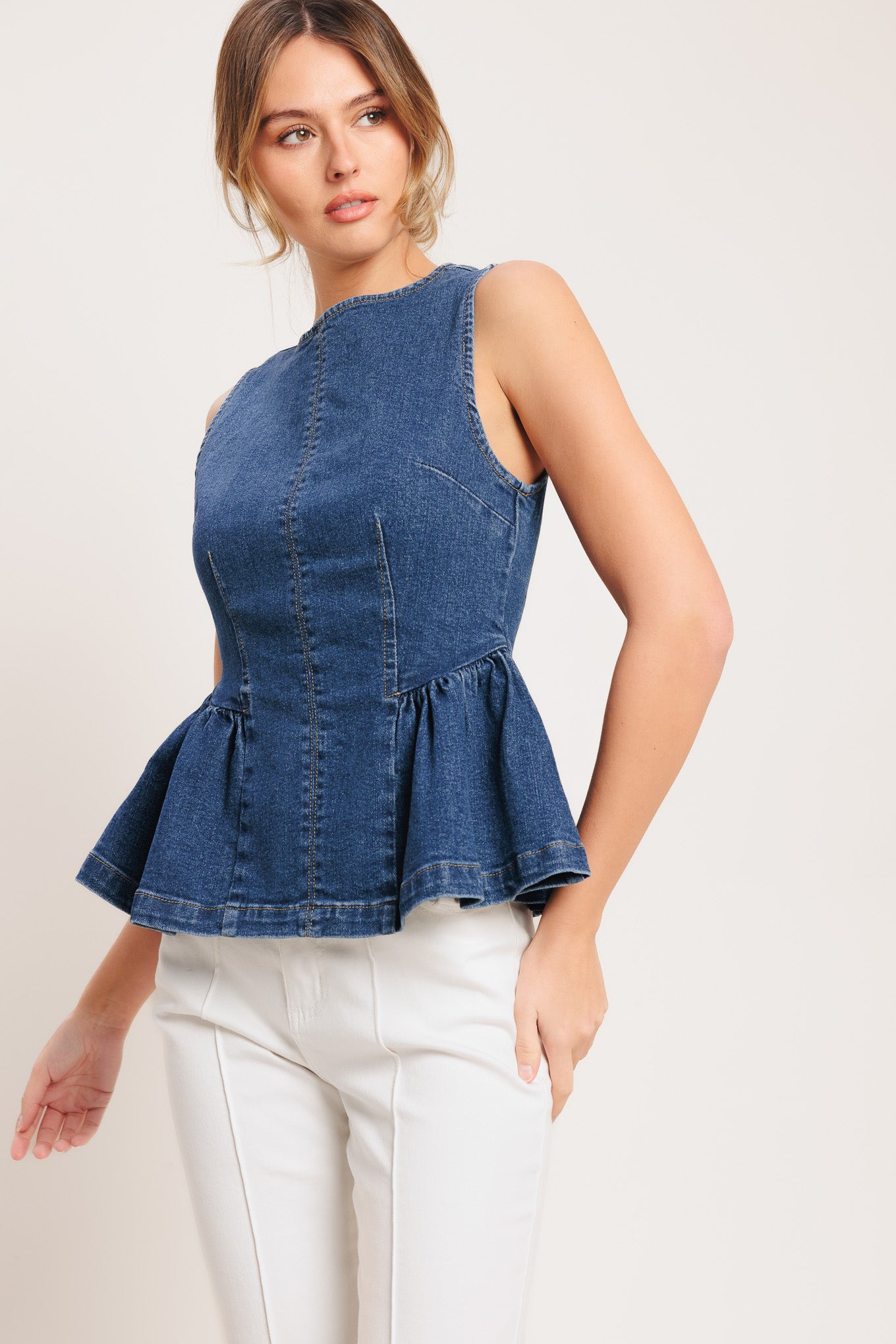 A washed denim top featuring round neckline, sleeveless, peplum and back zipper closure

Details:

Self: 85% Cotton 5% Polyester 8% Viscose 2% Spandex

Size & Fit

-Model is 5`8" And Wearing Size Small
-Measurements Taken From Size Small
-Approx. Length: 24"