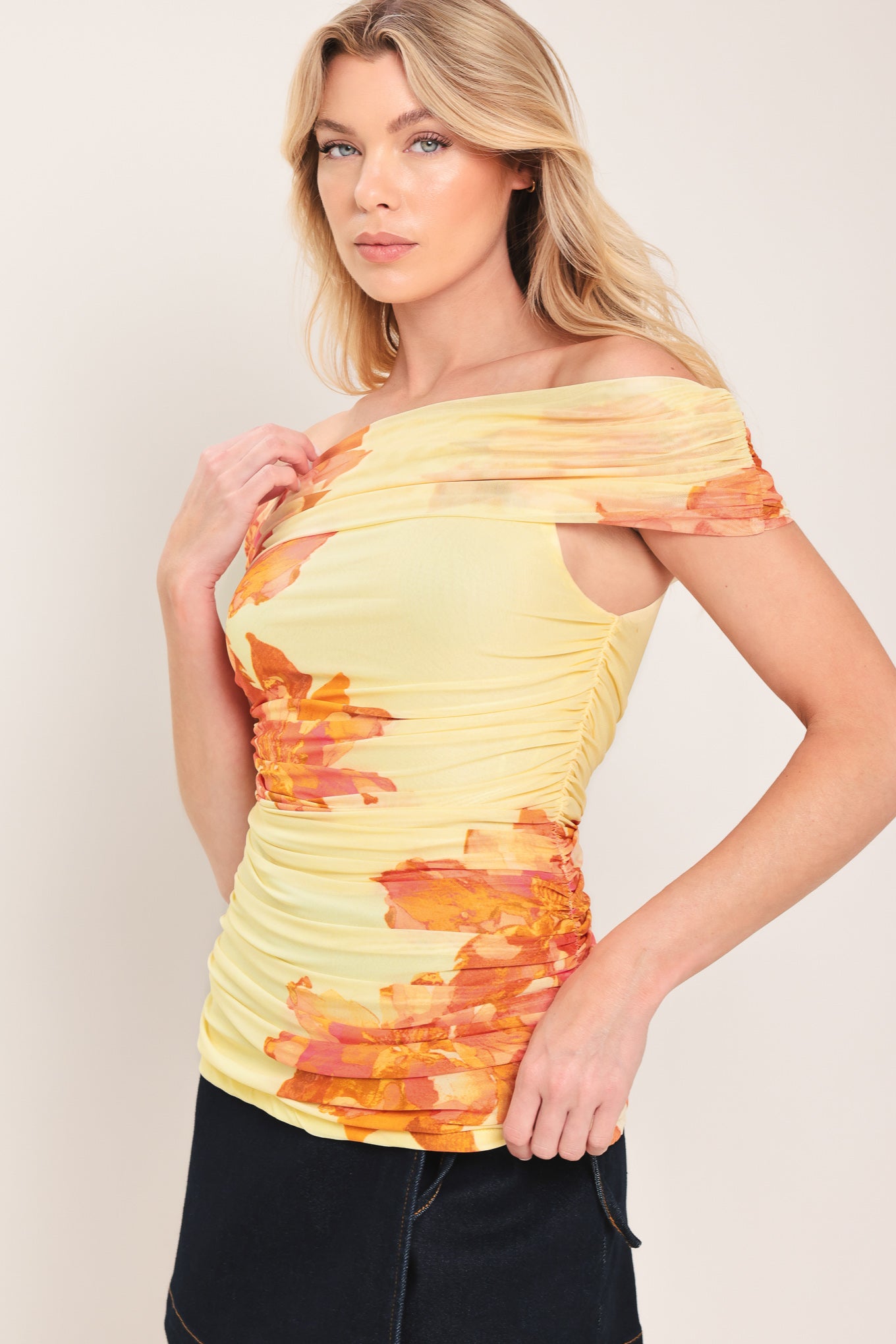 Woman wearing a yellow and orange floral off-shoulder power mesh top | Flying Tomato