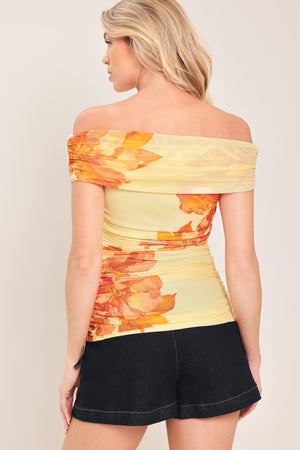 Woman wearing a yellow and orange floral off-shoulder power mesh top | Flying Tomato
