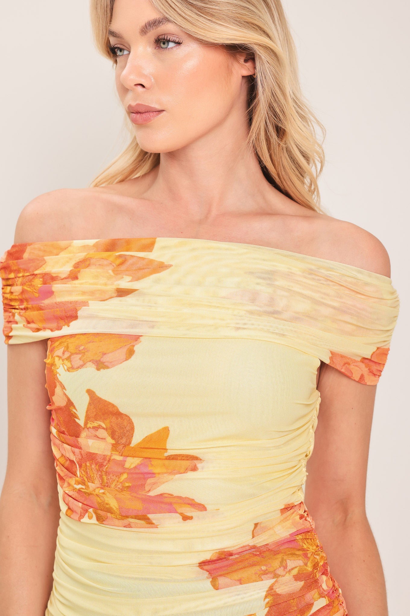 Woman wearing a yellow and orange floral off-shoulder power mesh top | Flying Tomato