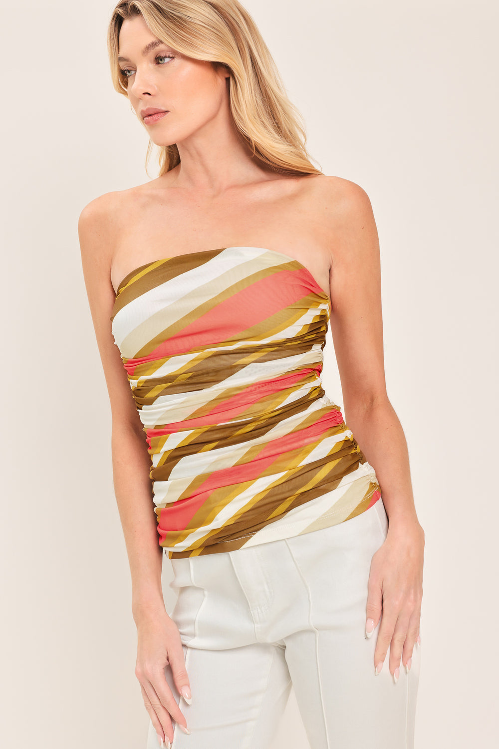 Woman wearing a colorful strapless tube mesh top with side shirring | Flying Tomato