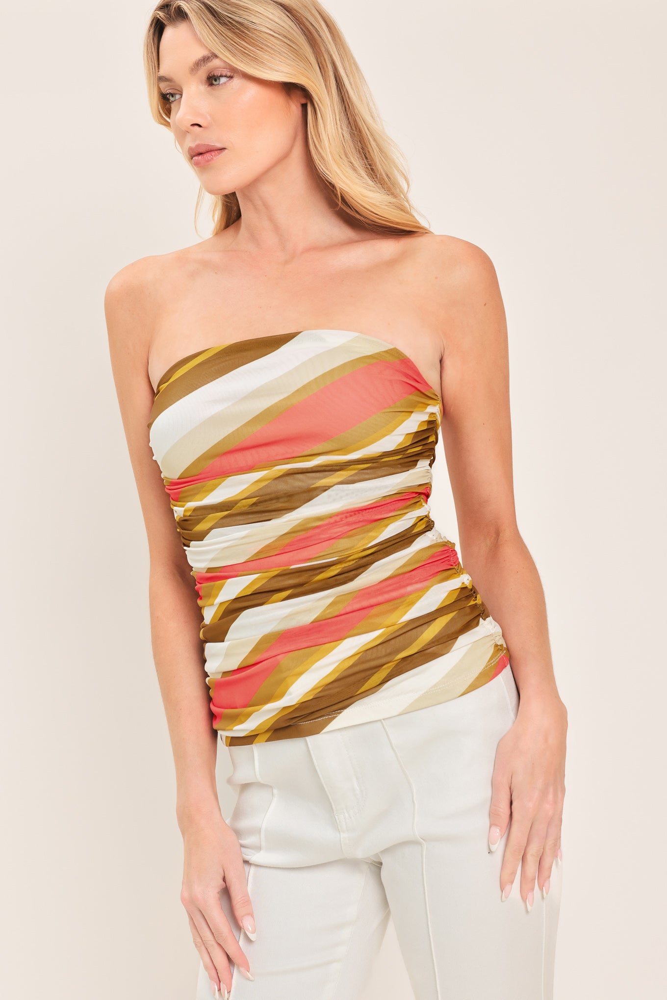 Woman wearing a colorful strapless tube mesh top with side shirring | Flying Tomato