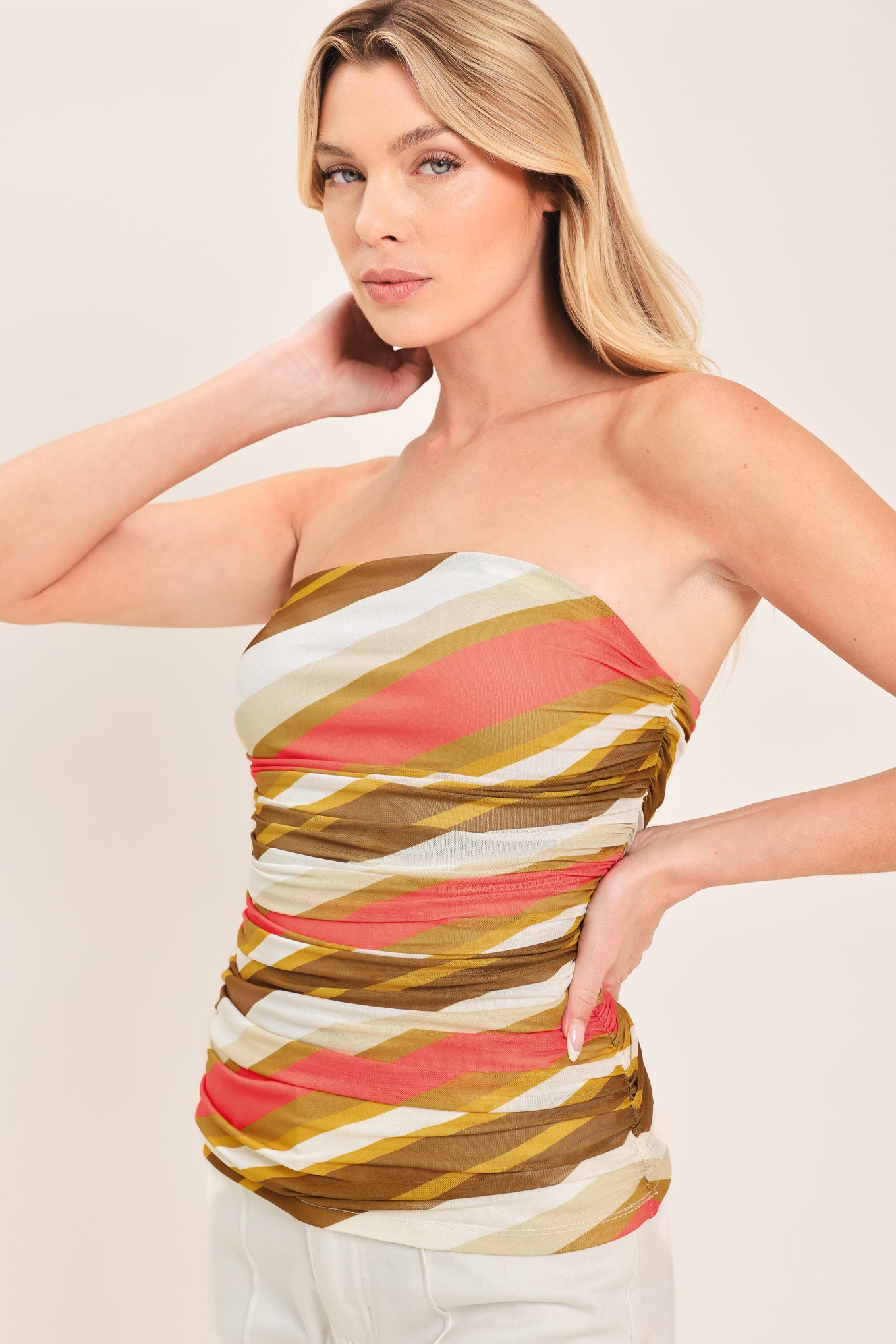 Woman wearing a colorful strapless tube mesh top with side shirring | Flying Tomato