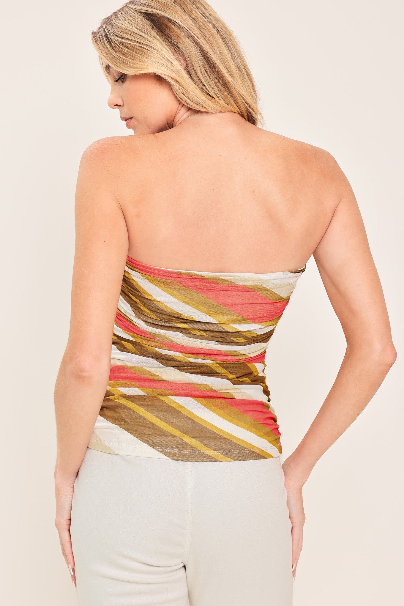 Woman wearing a colorful strapless tube mesh top with side shirring | Flying Tomato