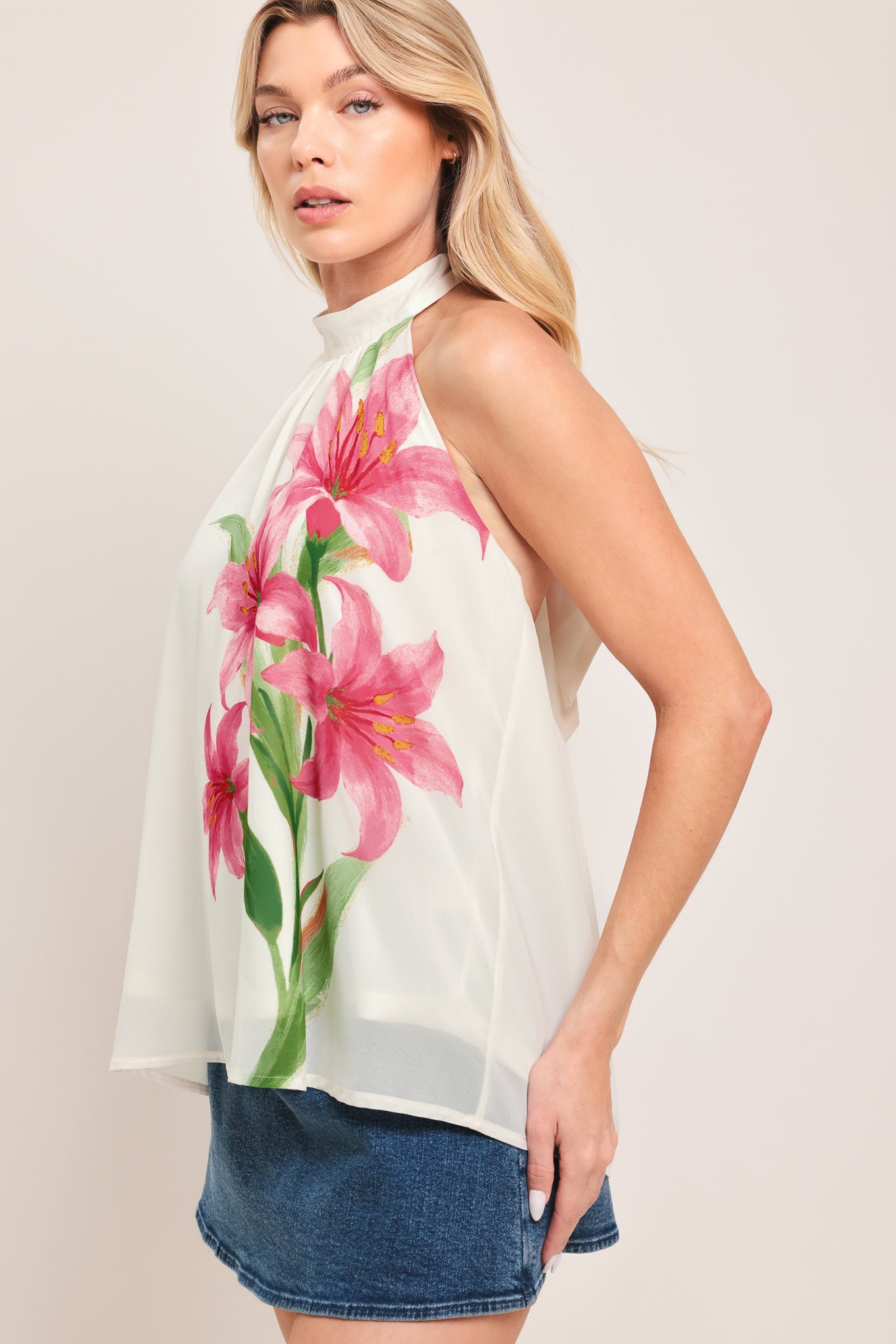 Woman wearing a floral halter top | Flying Tomato