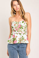 Woman wearing a floral strapless tube top with sweetheart neckline, peplum and back zipper closure | Flying Tomato