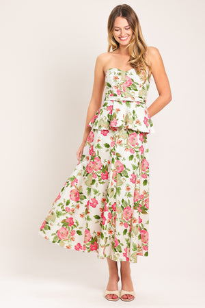 Woman wearing a floral strapless tube top with sweetheart neckline, peplum and back zipper closure | Flying Tomato