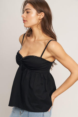 A black solid woven top featuring twisted bodice with bead trim, straps and back zipper closure