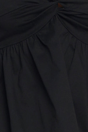 A black solid woven top featuring twisted bodice with bead trim, straps and back zipper closure
