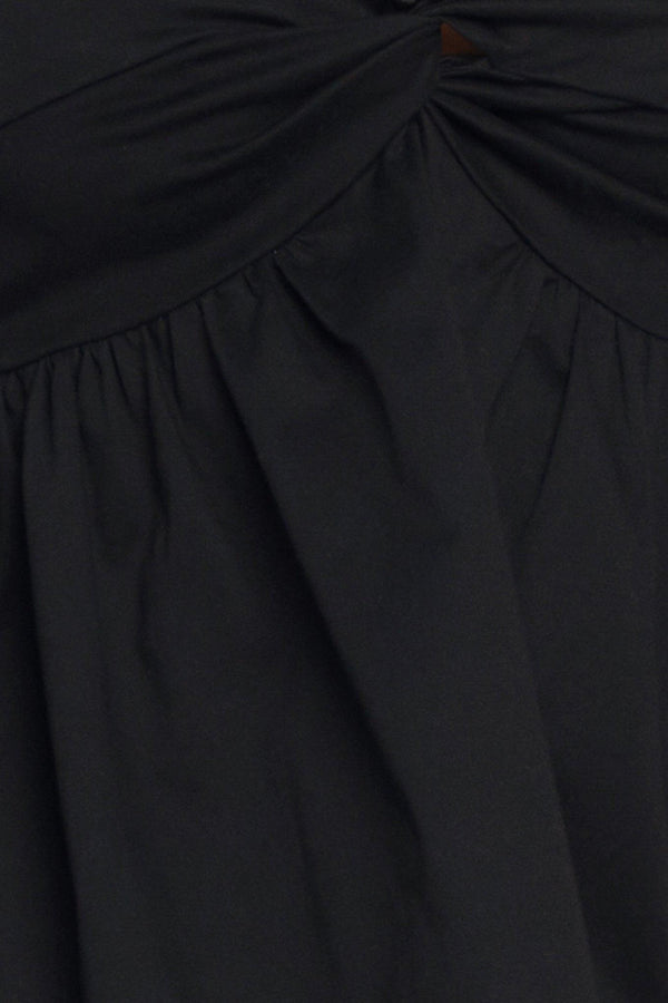 A black solid woven top featuring twisted bodice with bead trim, straps and back zipper closure