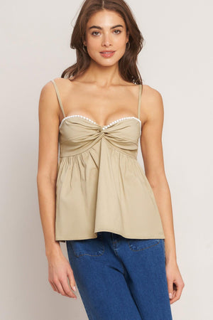 A taupe solid woven top featuring twisted bodice with bead trim, straps and back zipper closure