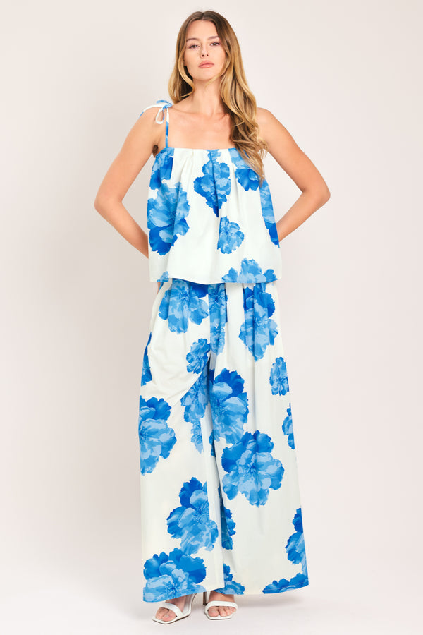 Woman wearing a blue floral top with shoulder ties | Flying Tomato