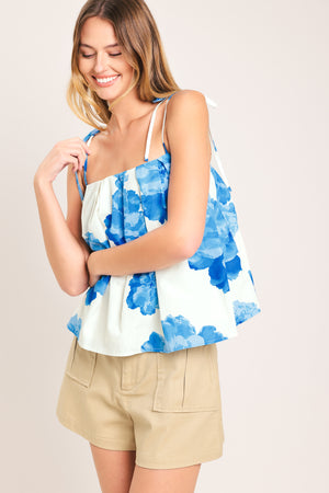 Woman wearing a blue floral top with shoulder ties | Flying Tomato