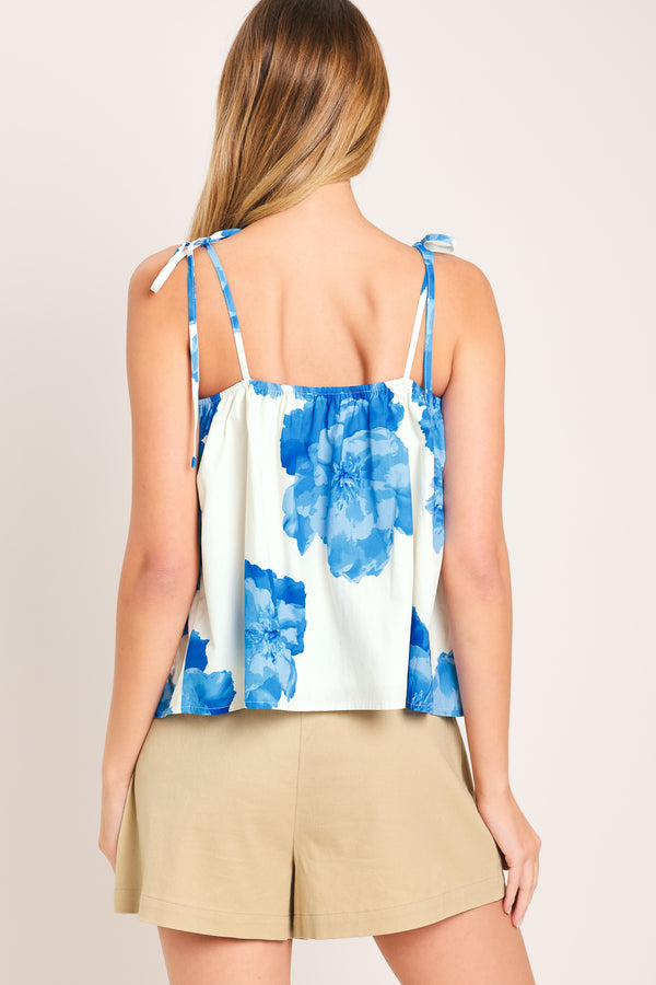 Woman wearing a blue floral top with shoulder ties | Flying Tomato