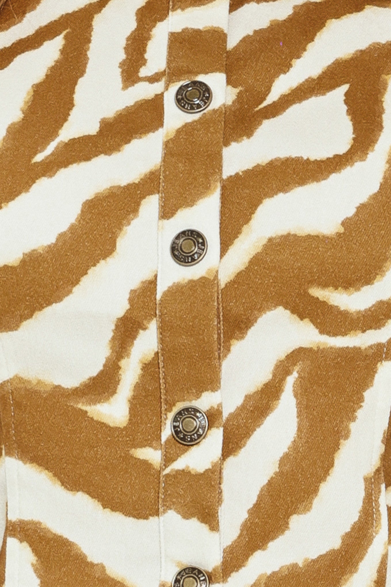 Close-up of a crop top with brown and white zebra pattern and metallic buttons | Flying Tomato