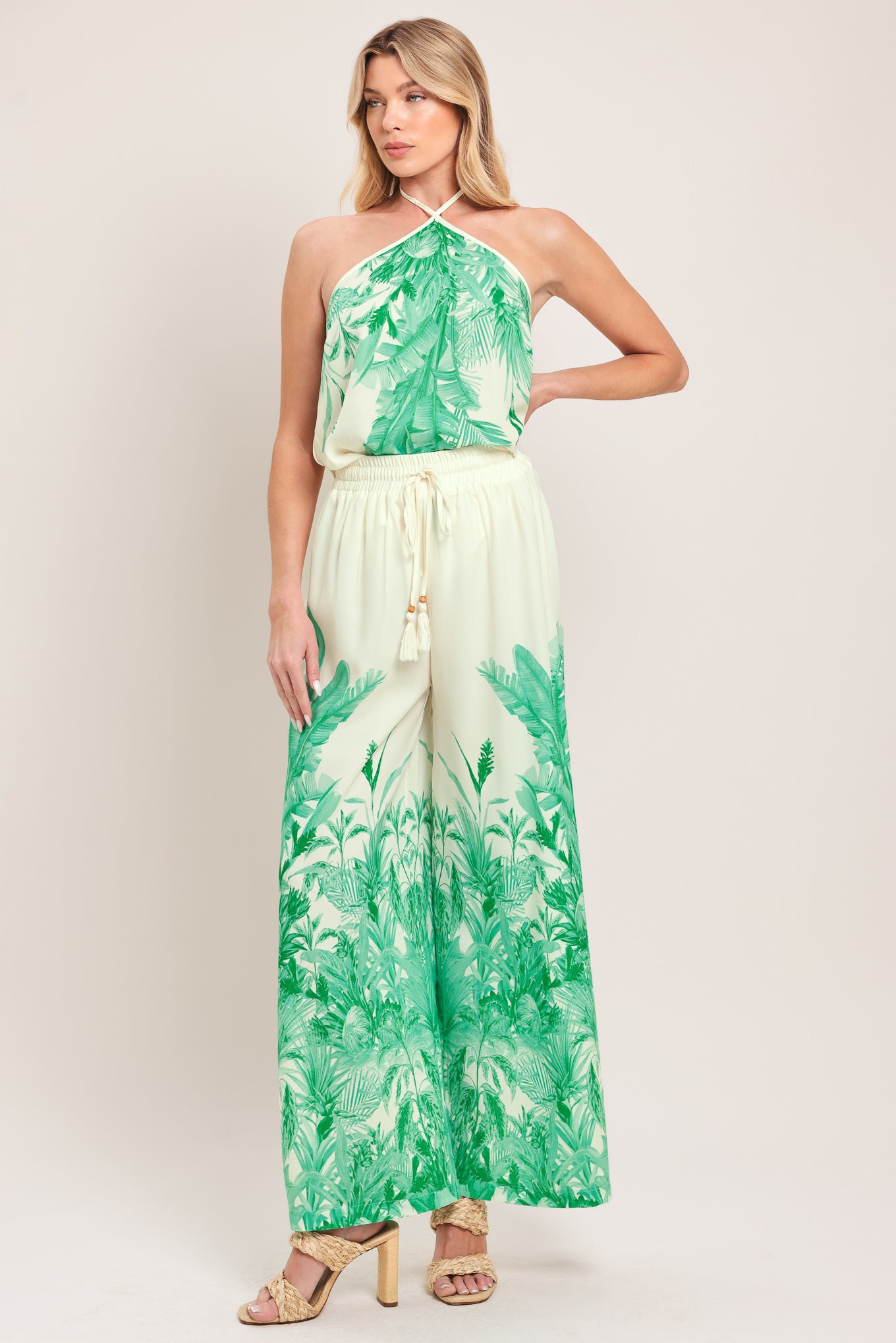Woman wearing a halter top and pants set with green leaf pattern | Flying Tomato