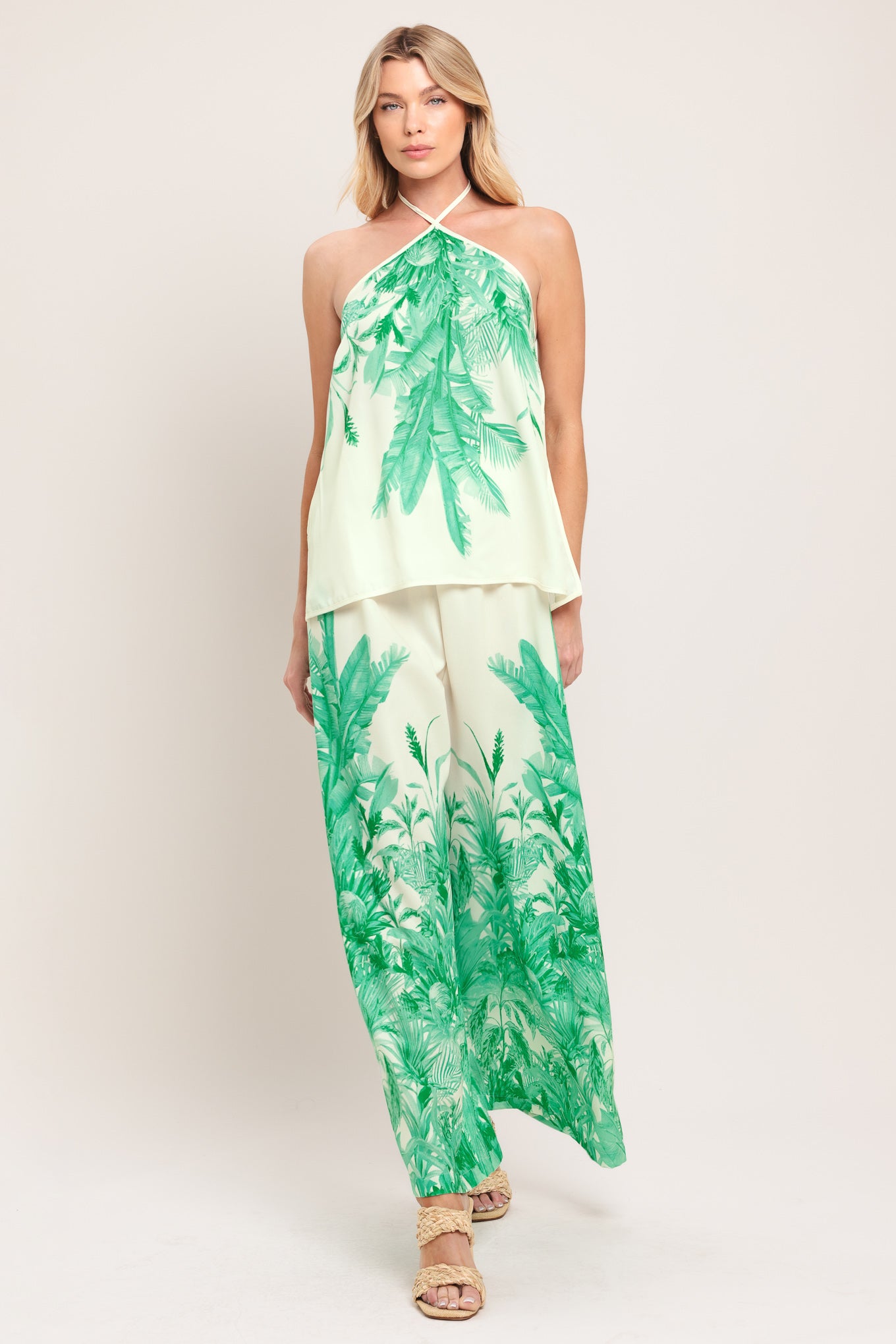 Woman wearing a halter top and pants set with green leaf pattern | Flying Tomato