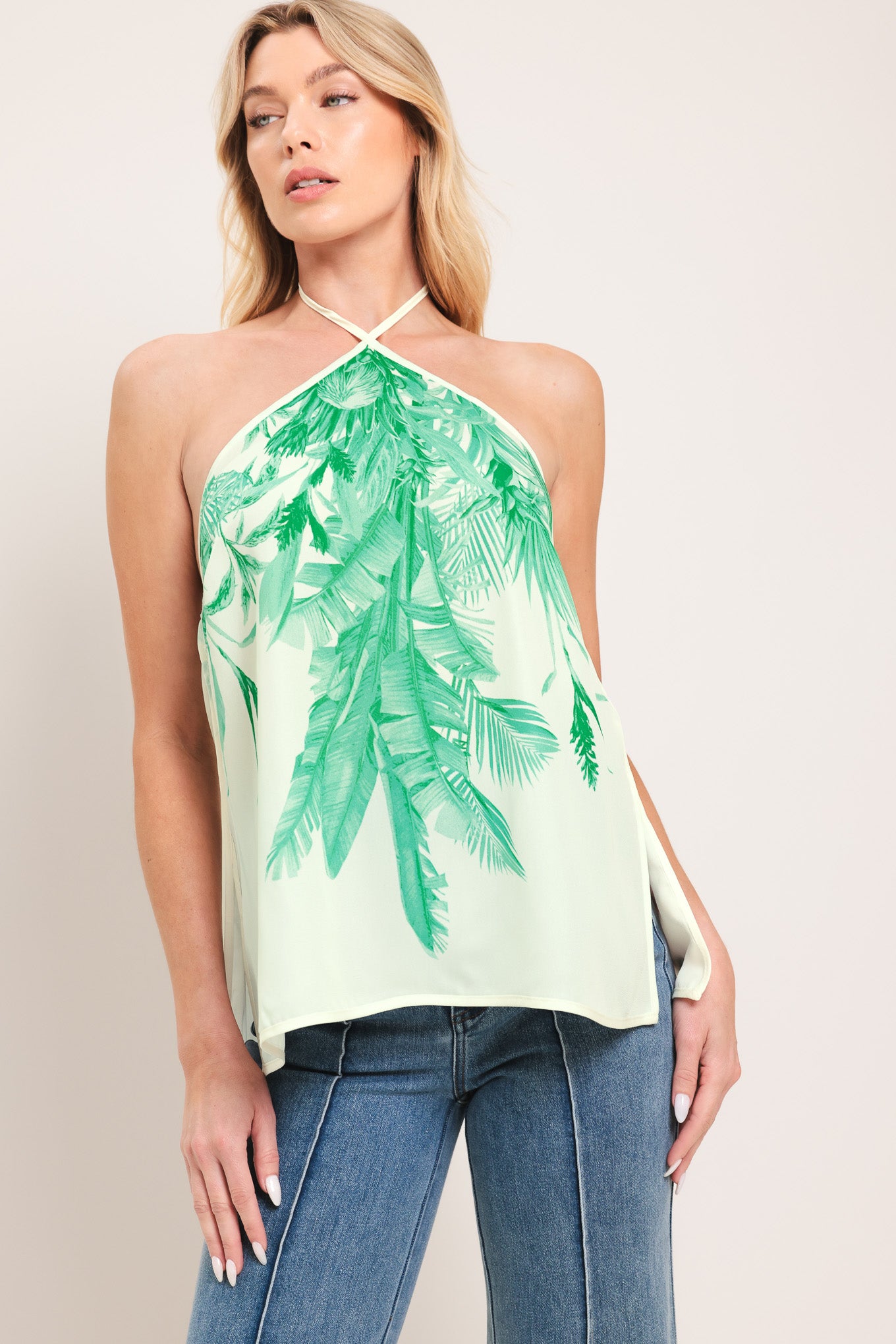 Woman wearing a halter top with green leaf pattern | Flying Tomato