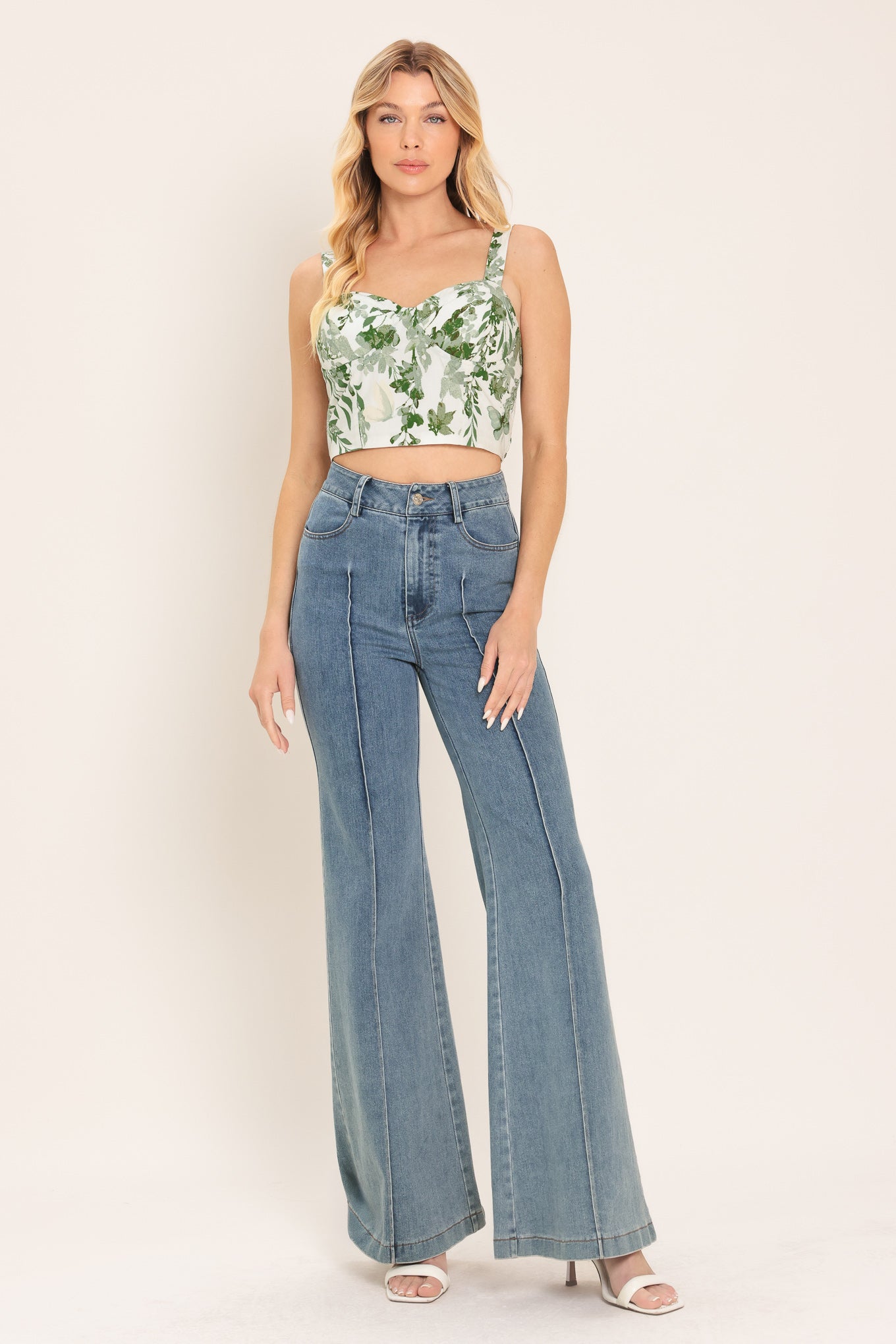Woman wearing a green floral crop bustier top with smocked back bodice | Flying Tomato