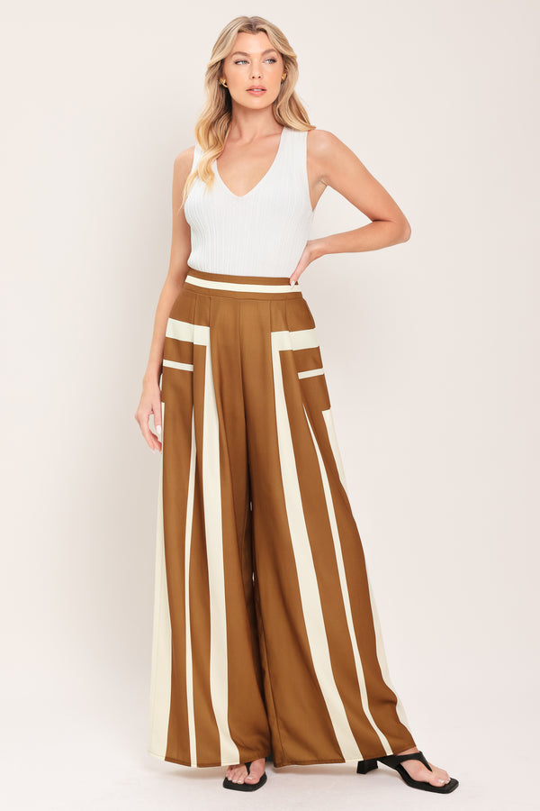 Woman wearing a brown and white geometrical pants featuring wide leg pant with elastic back | Flying Tomato