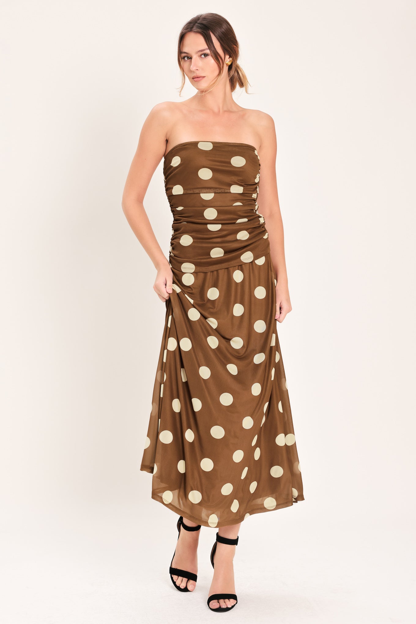 Woman wearing a brown strapless power mesh top with white polka dots and side shirring | Flying Tomato