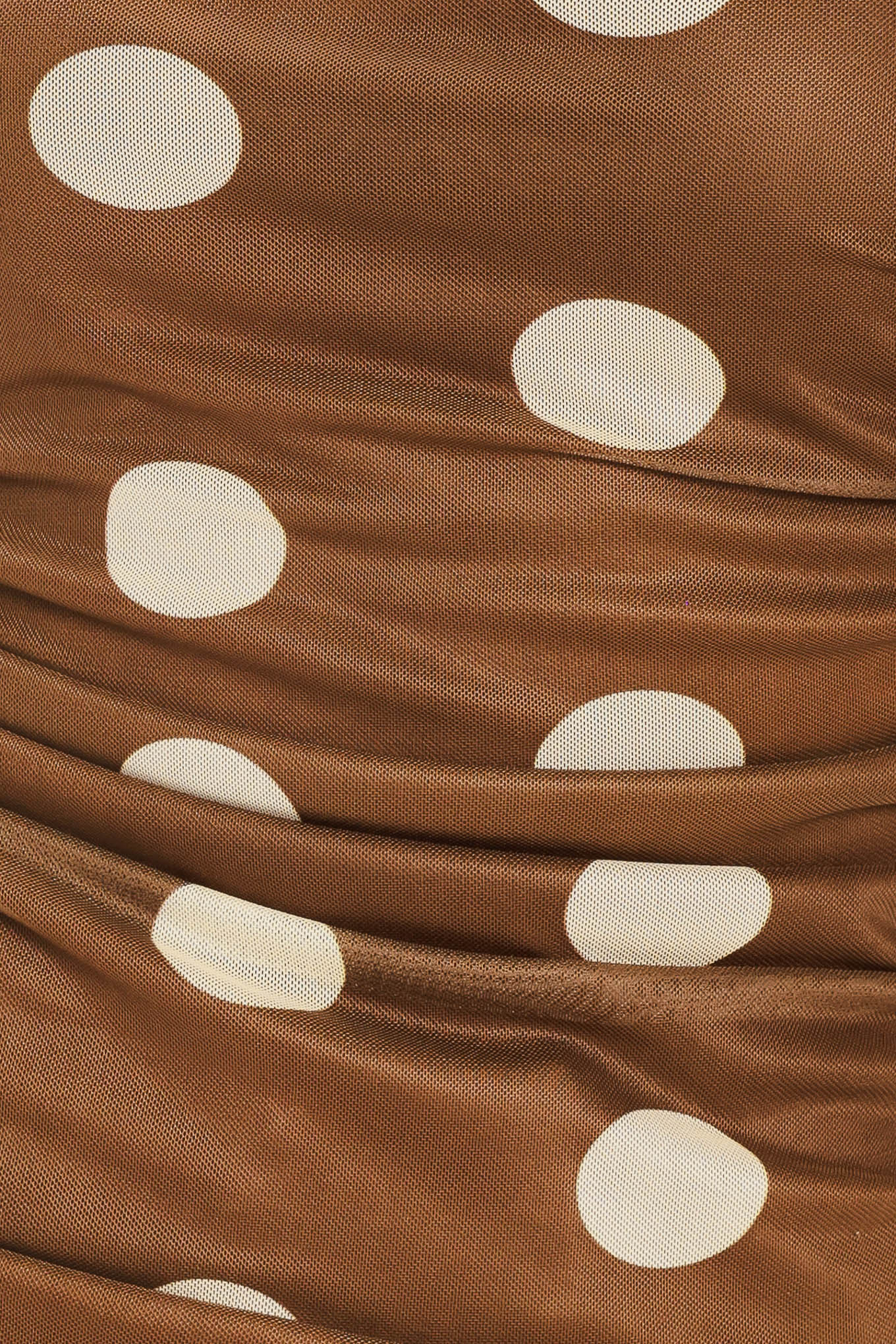 Woman wearing a brown strapless power mesh top with white polka dots and side shirring | Flying Tomato
